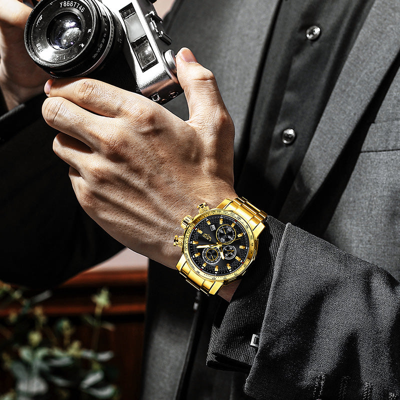 Person holding a vintage camera with a gold wristwatch on a blurred background